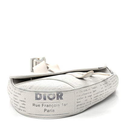 X Daniel Arsham Grained Calfskin Newspaper Print Saddle Bag White